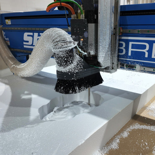 3D printing process with a machine extruding material onto a platform.